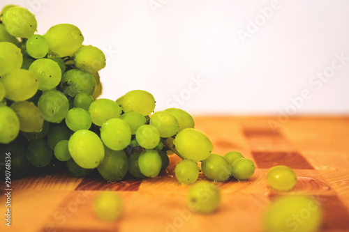 Green grape on the wooden cutting board photo