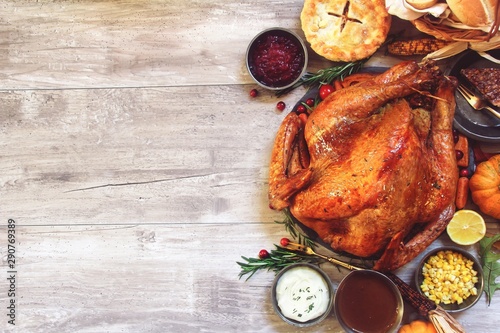 Quadro su tela Thanksgiving  feast concept with roasted Turkey gravy cranberry sauce and dinner
