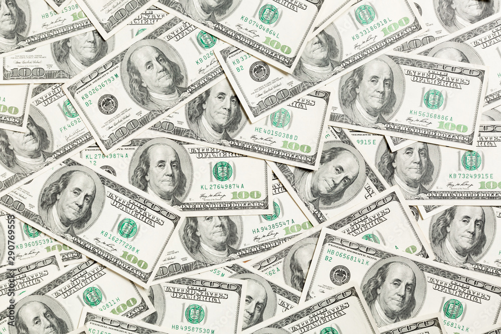Top view of one hundred dollar banknotes made as a background. USD currency concept. Texture of American dollars Top view of one hundred dollar banknotes made as a background. USD currency concept. Texture of American dollars