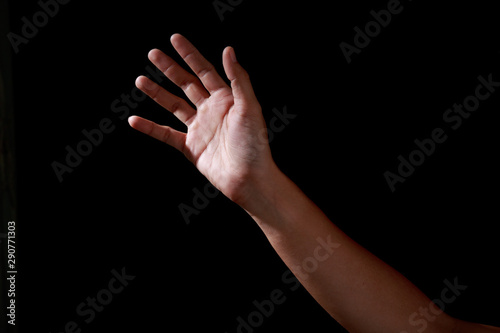 Man hands in praying position low key image. High Contrast