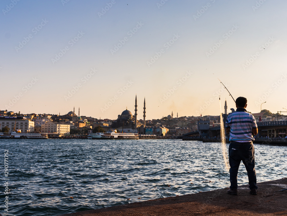 fisherman fishing in Istanbul at golden horn