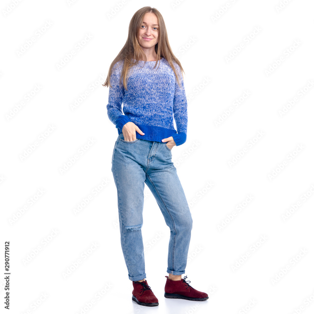 Woman in jeans and blue sweater smiling standing on white background isolation Woman in jeans and blue sweater smiling standing on white background isolation
