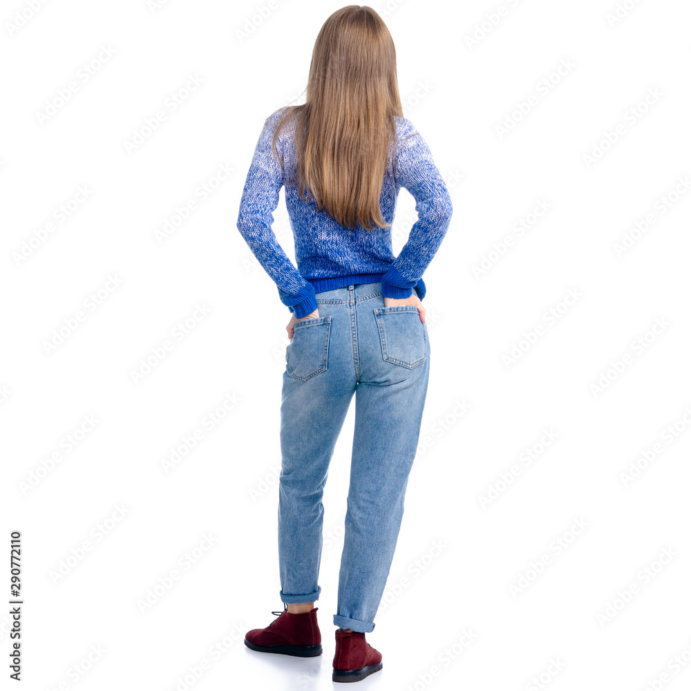 Obraz premium Woman in jeans and blue sweater looking standing on white background isolation, rear view