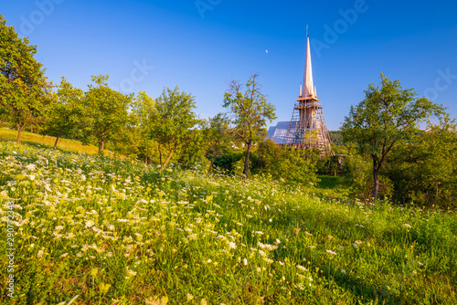 Scenic rural landscape with traditional maramures wooden church, Plopis, Maramures County, Romania photo