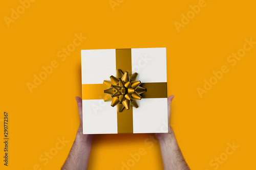 man offering a gift coloured background
