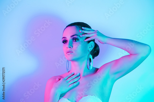 Studio portrait of fashion model in neon lights