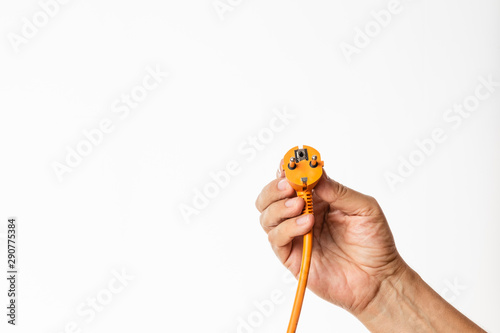 male hand holding an electric plug isolated in white background