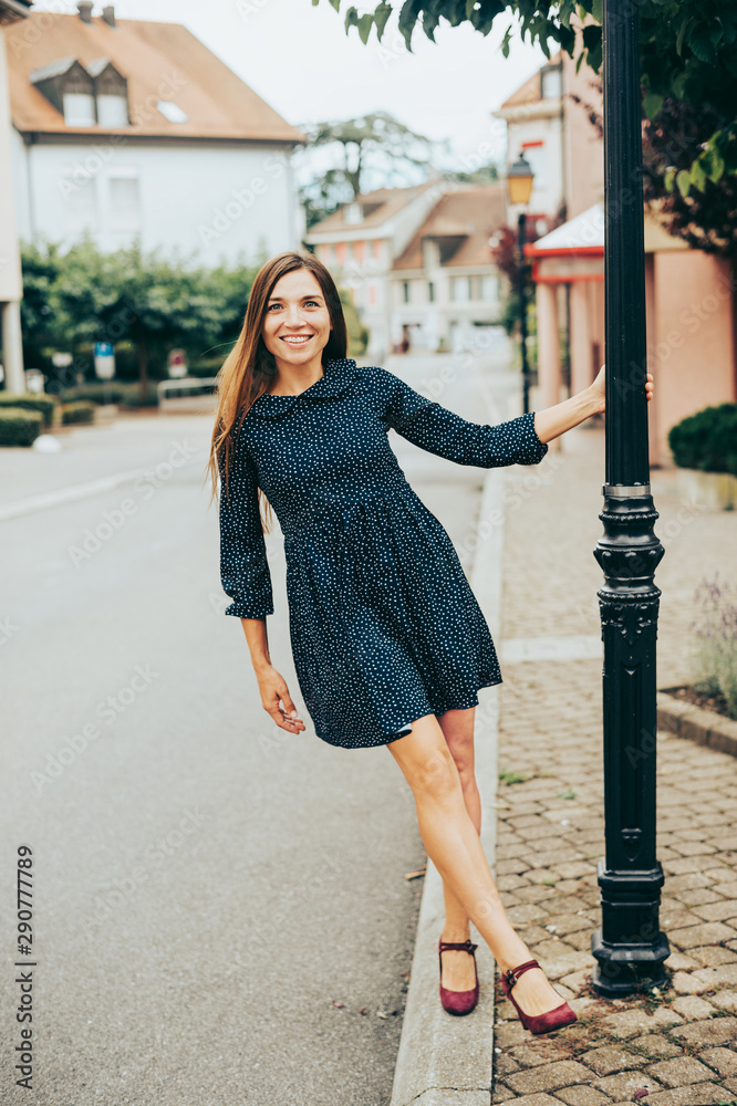 Outdoor portrait of happy beautiful woman, wearing mini dress Outdoor portrait of happy beautiful woman, wearing mini dress