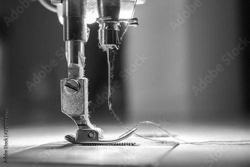Photography Close-up needle of white industrial sewing machine use sew cloth with black and white tone (monochrome)
