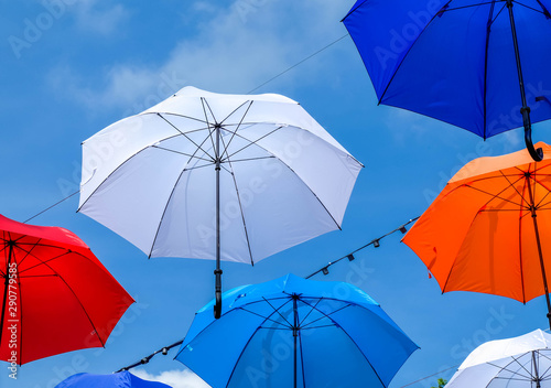 Colorful umbrellas background. Colorful umbrellas in the sky. Street decoration. © piyaphong