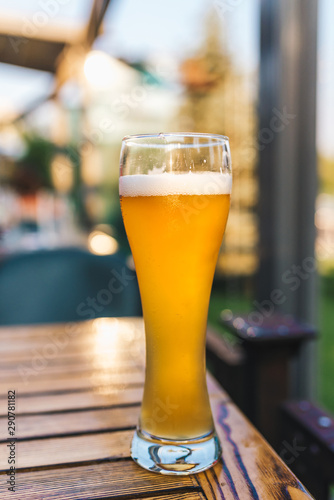 A glass of beer on a wooden table in a restaurant