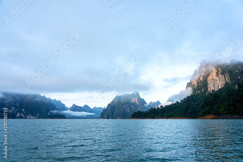 Limestone mountain range in morning light with mist and clouds photo