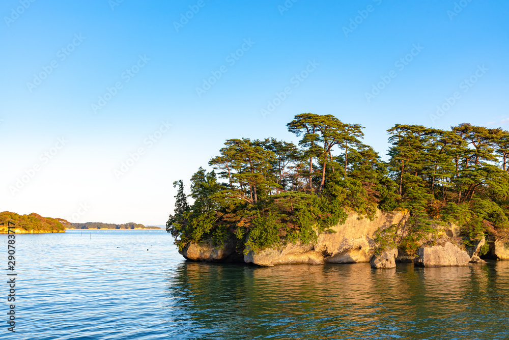 Obraz premium Matsushima Bay in dusk, beautiful islands covered with pine trees and rocks. One of the Three Views of Japan, and is also the site of the Zuigan-ji, Entsu-in and Kanrantei. in Miyagi Prefecture, Japan