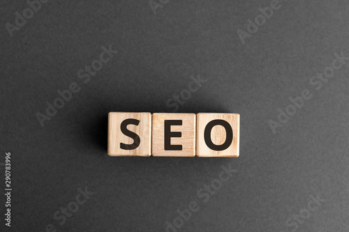 SEO - wooden blocks with letters, search engine optimization SEO concept, top view on grey background