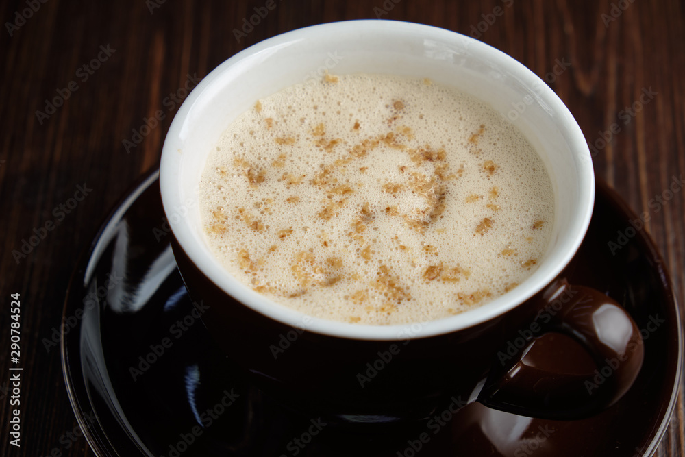 Cappuccino on a brown wooden background. Menu Cappuccino on a brown wooden background. Menu