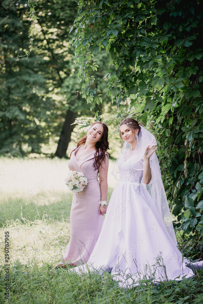 Bride and bridesmaid on a green background