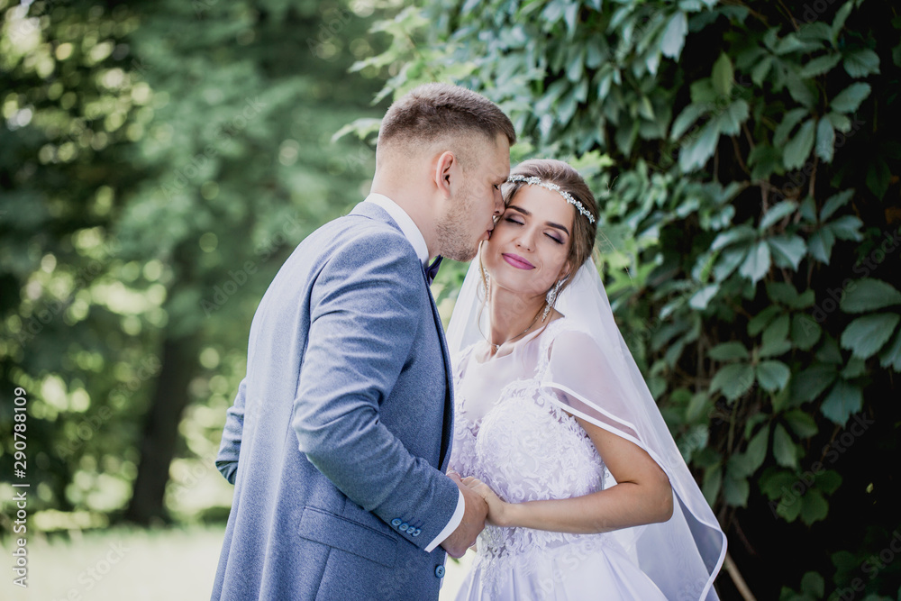 The groom kisses the bride