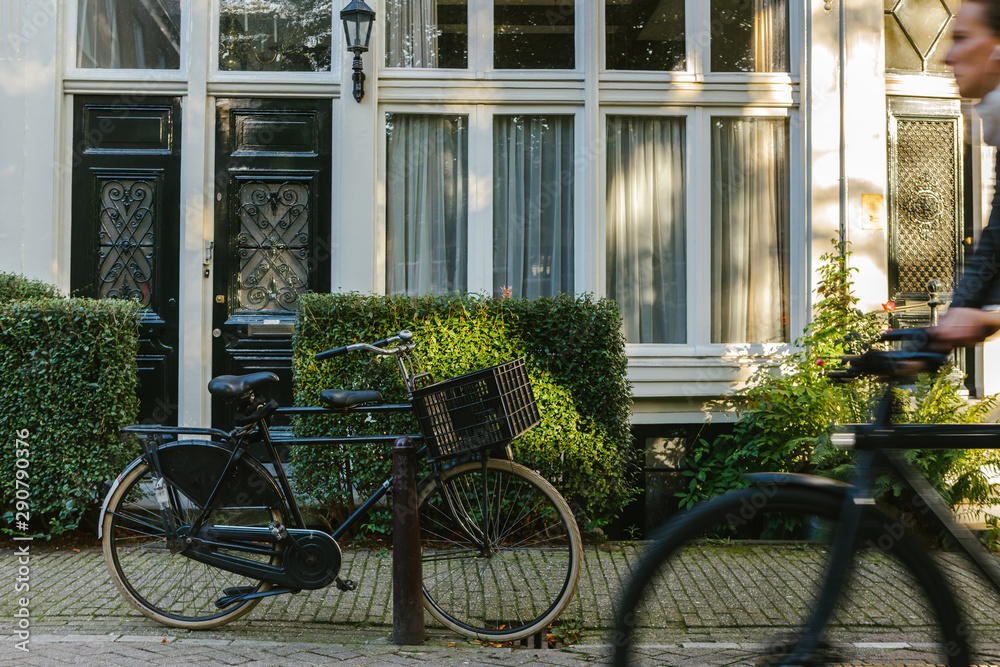 Bicycle parked on a bridge above the water in Amsterdam