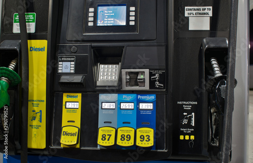 Close up of generic gas pumps showing the different grades of petrol and payment keypad.