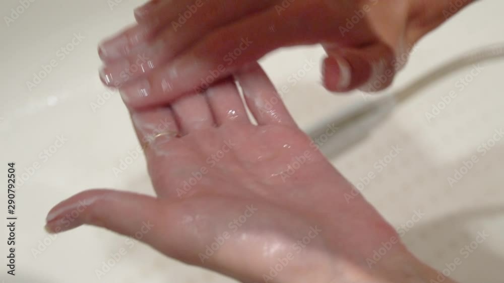 Clean well-groomed hands of a young woman applying hand cream, Clean well-groomed hands of a young woman applying hand cream,