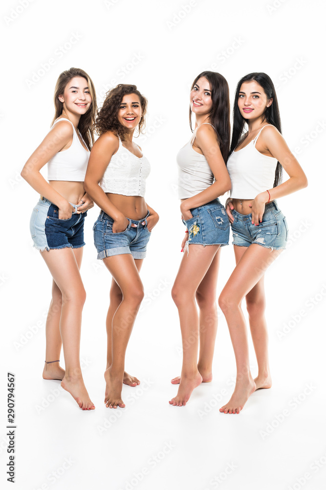 Full length portrait of a happy four girls isolated on a white background