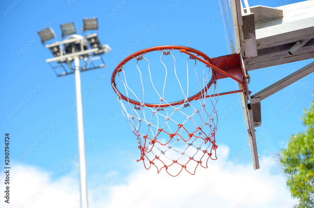 bright blue sky with basketball hoop and spotlight bright blue sky with basketball hoop and spotlight