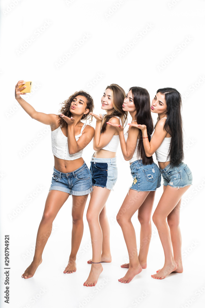 Obraz premium Four young girls friends taking selfie isolated on white background
