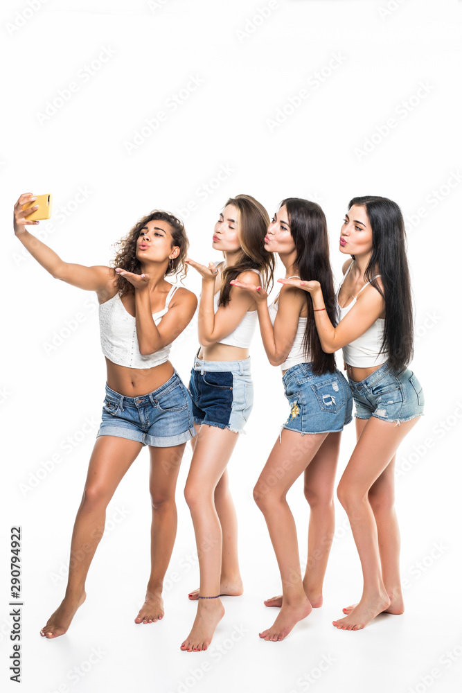 Young beauty women wear shirts and shorts selfie on phone isolated on white background Young beauty women wear shirts and shorts selfie on phone isolated on white background