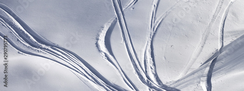 Off-piste slope with track from ski and snowboard on sunny evening