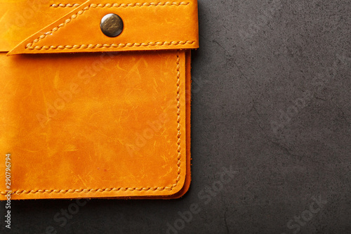 Wallet made of genuine brown nubuck leather on a dark background. Handmade leather items
