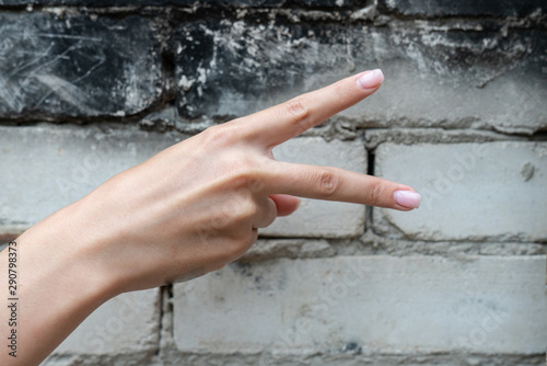 Girls hand showing pointing up two fingers, victory hand gesture