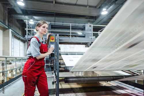 Worker monitoring the nightly printing process of a newspaper
