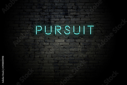 Highlighted brick wall with neon inscription pursuit