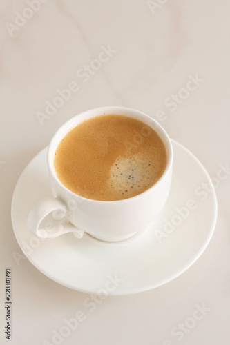  cup with black coffee on a white marble background