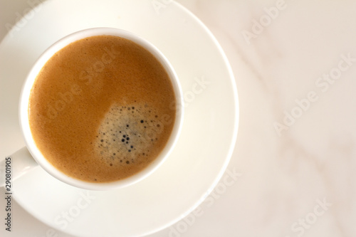 white cup with black coffee on a white background and place for text