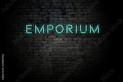 Highlighted brick wall with neon inscription emporium