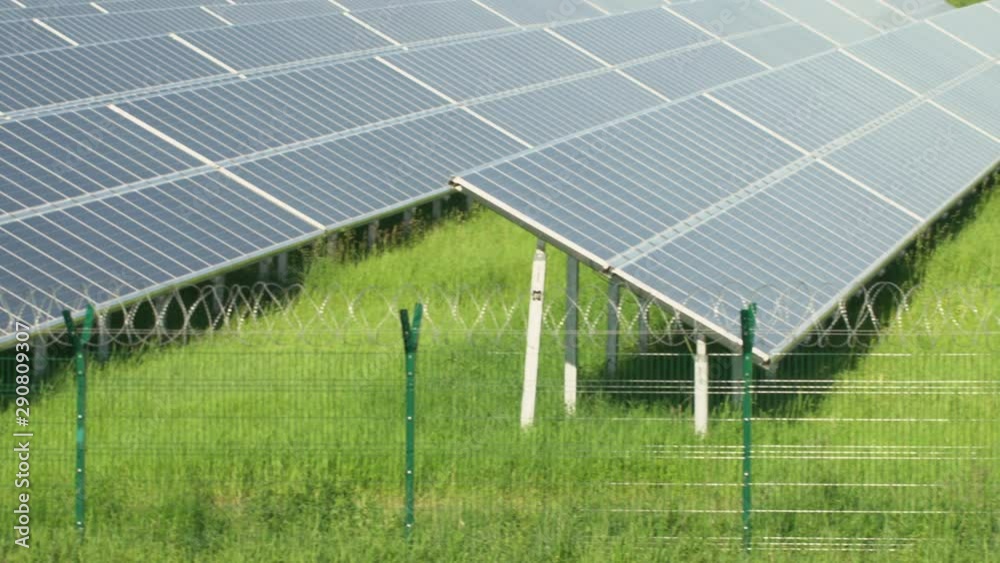 Solar panels in a mountainous area near the road. Around the fence with barbed wire. Solar panels in a mountainous area near the road. Around the fence with barbed wire.