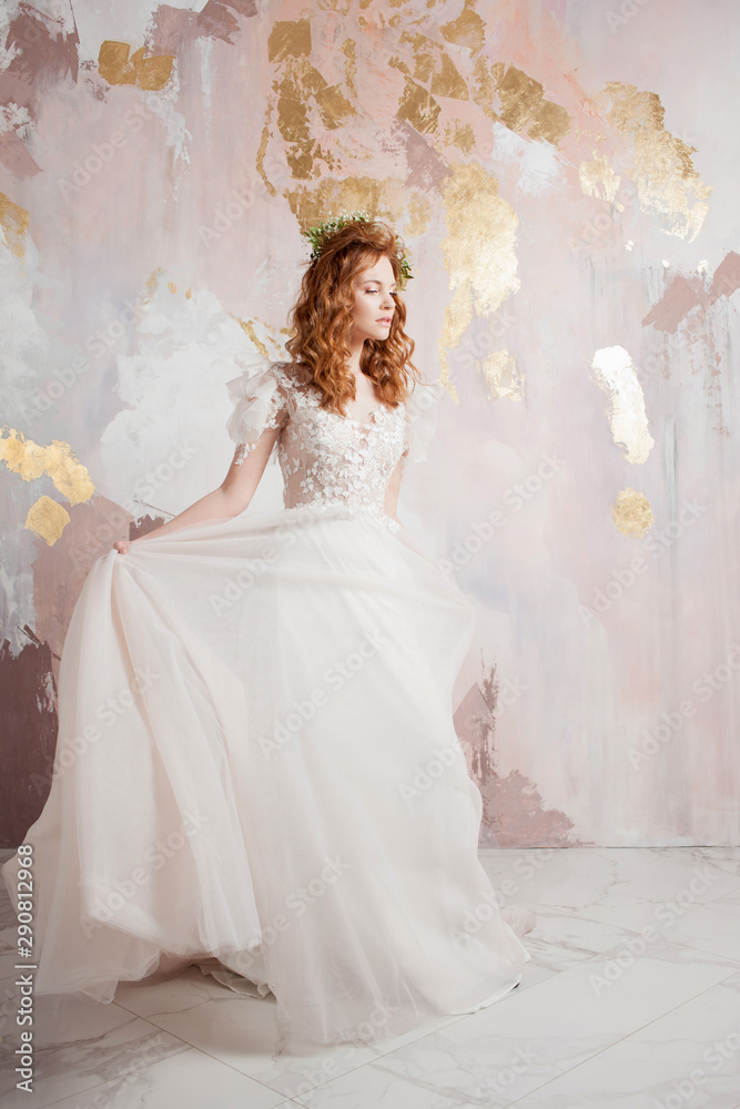 Elegant red-haired girl bride. Young beautiful woman in wedding dress Elegant red-haired girl bride. Young beautiful woman in wedding dress