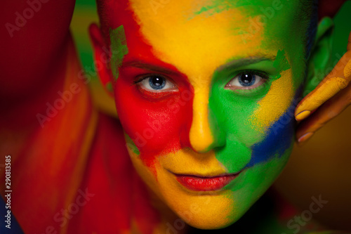 Foto Portrait of the bright beautiful young woman with face art and body art