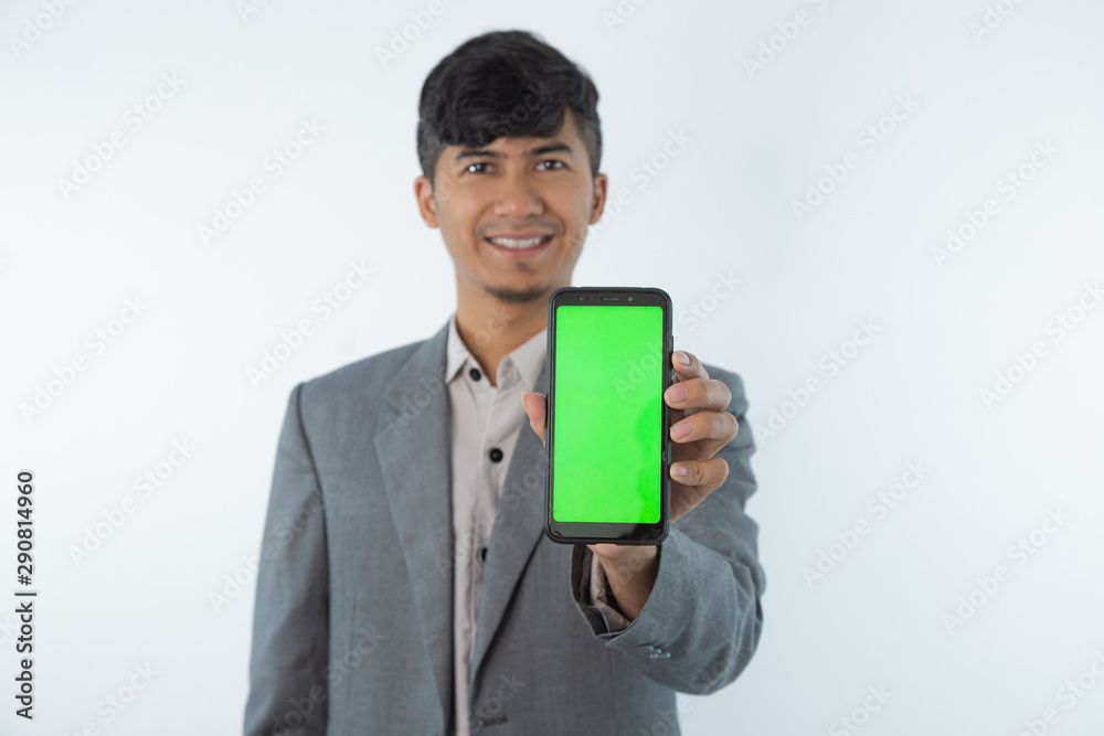 Portrait of Asian Young Business man showing smart cell phone with green screen phone isolated on white background. Portrait of Asian Young Business man showing smart cell phone with green screen phone isolated on white background.