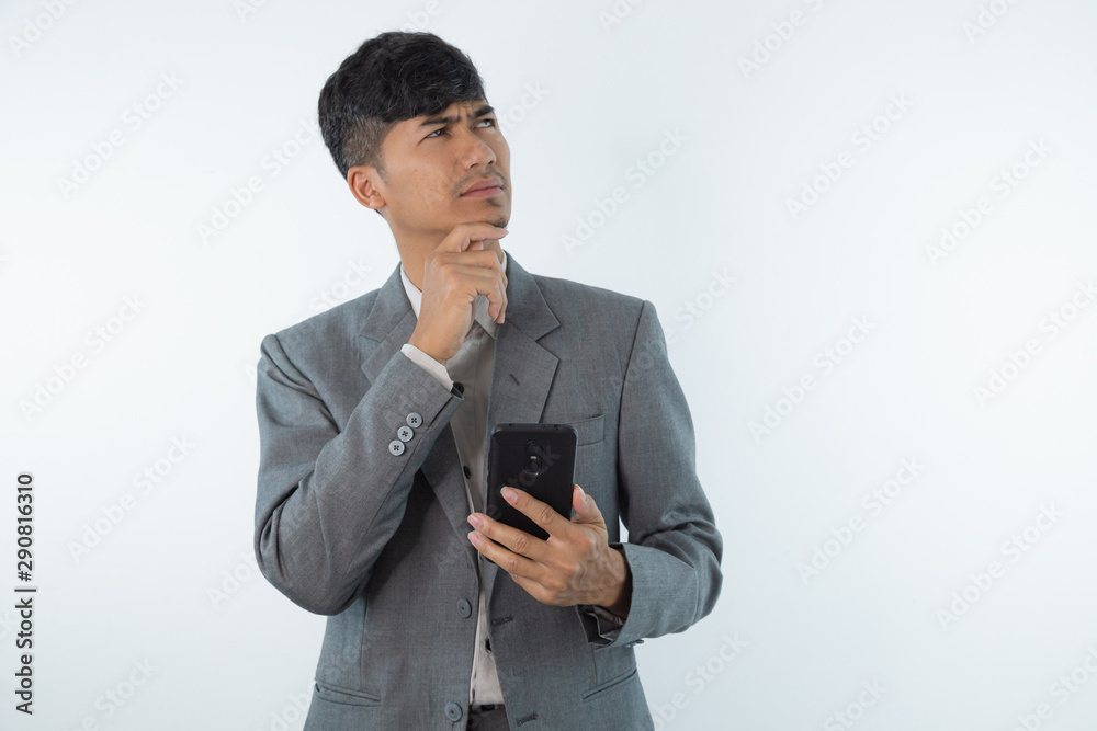 Young business asian man thinking of an idea isolated on white background. Young business asian man thinking of an idea isolated on white background.