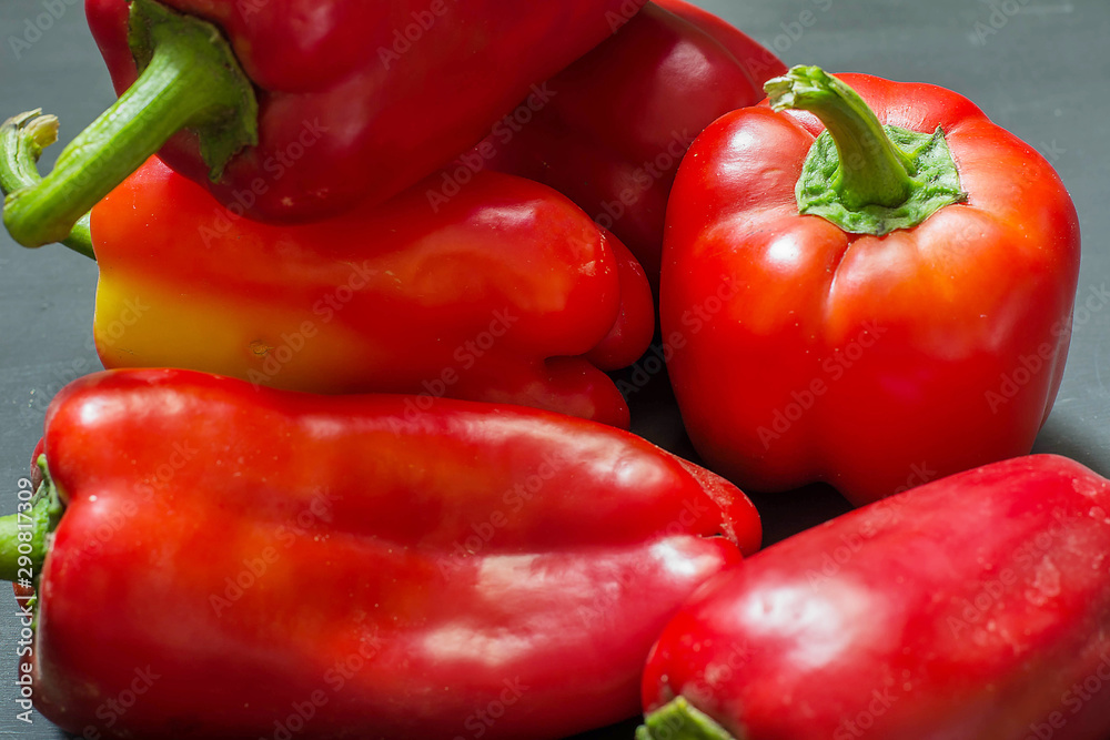 Red sweet pepper close-up on a black table. Red sweet pepper close-up on a black table.