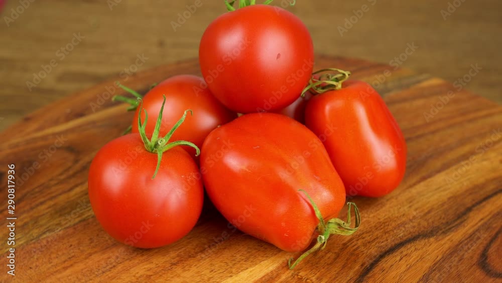 Red tomatoes piled on a rotating wooden plate Red tomatoes piled on a rotating wooden plate