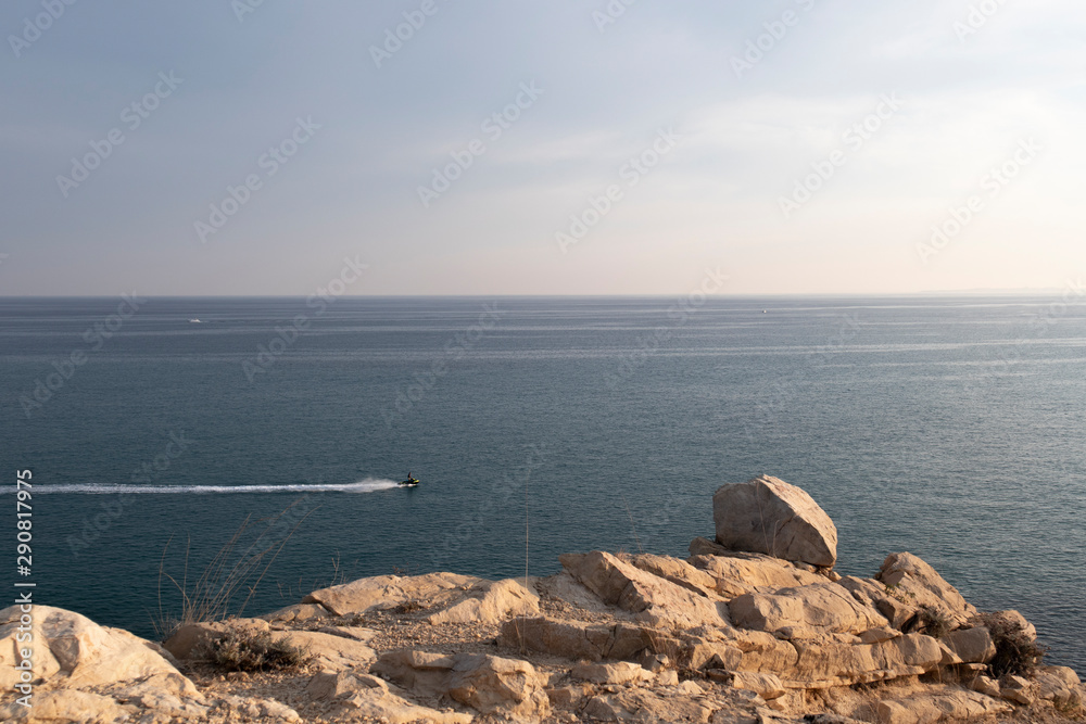 Water scooter in the mediterranean seen from a cliff Water scooter in the mediterranean seen from a cliff