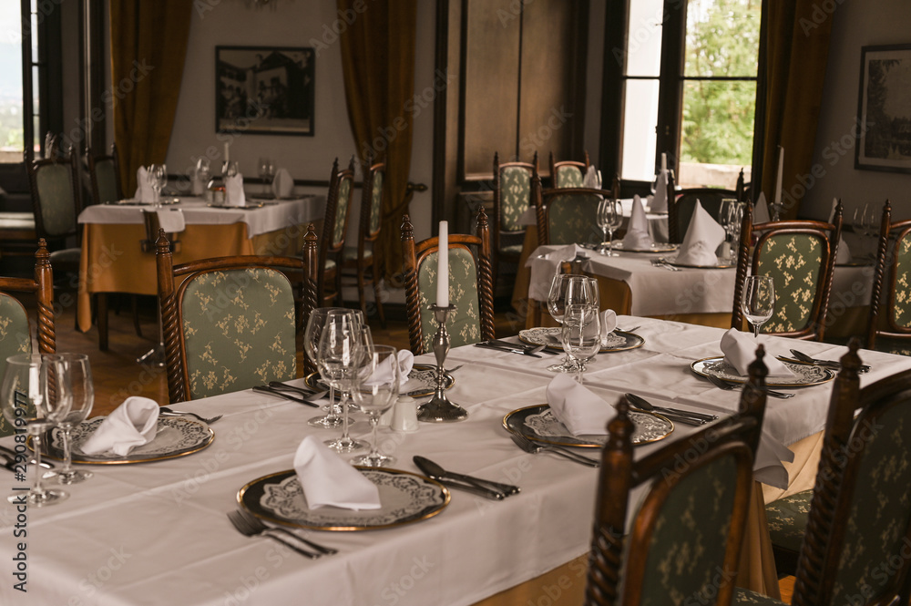 Interior of a classic restaurant in an old castle. Traveling in Europe. Served tables and antiquity.
