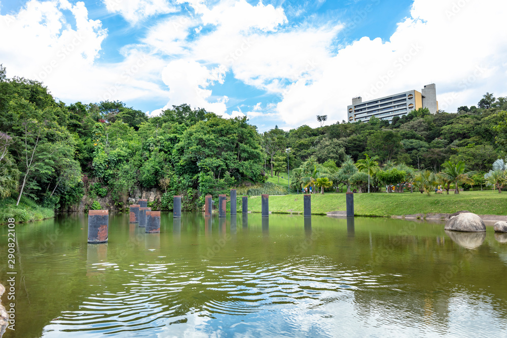 Obraz premium Lake in a public outdoor park surrounded by green trees and exercise toys in Jundiai, Sao Paulo, Brazil