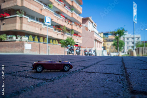 Classic toy car in the street, pretending to be real.