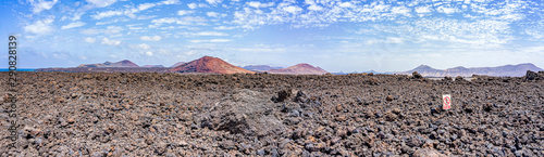 Panoramic shot of the rugged lava landscape with the volcanoes on Lanzarote, Spain