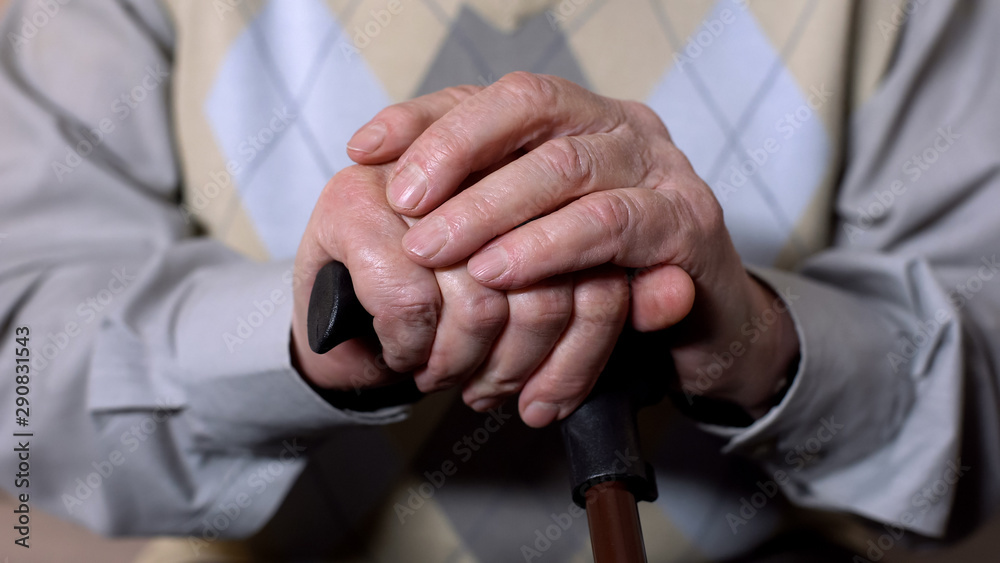 Obraz premium Aged male hands holding walking stick, social pension reform, health care