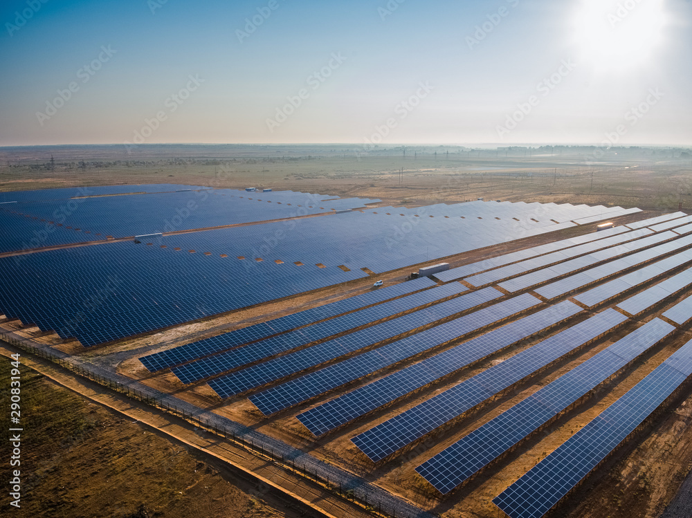 Solar Power Station - Aerial View: Long Rows of Solar Panels at Sunset